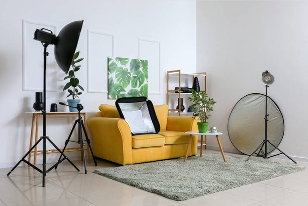 Interior of stylish photo studio with modern furniture and different equipment - 写真・画像