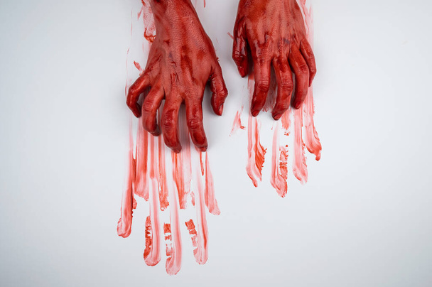 Female hands in blood on a white background.  - Foto, afbeelding