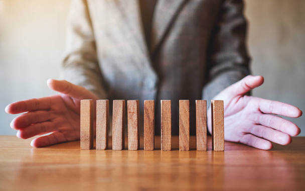Closeup image of a businessman showing wooden block for business success concept - Photo, Image