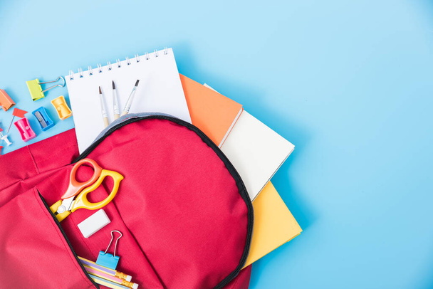 Top view flat lay of red school bag backpack and accessories tools for children education on blue background, Back to school concept and have copy space for use - Φωτογραφία, εικόνα