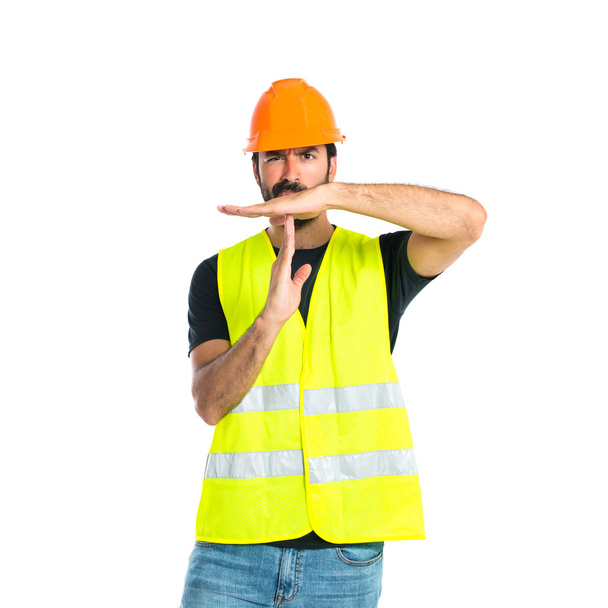 Workman making time out gesture over white background - Φωτογραφία, εικόνα