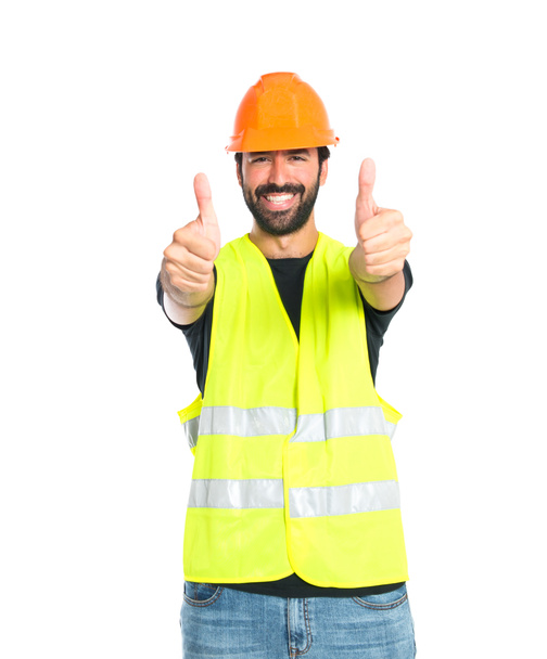 workman met duim omhoog op witte achtergrond - Foto, afbeelding