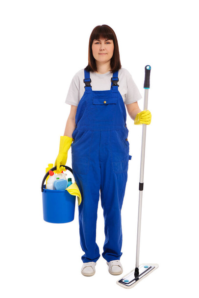 professional cleaning service concept - portrait of young woman cleaner in blue uniform posing with mop and cleaning equipment isolated on white background - Photo, image