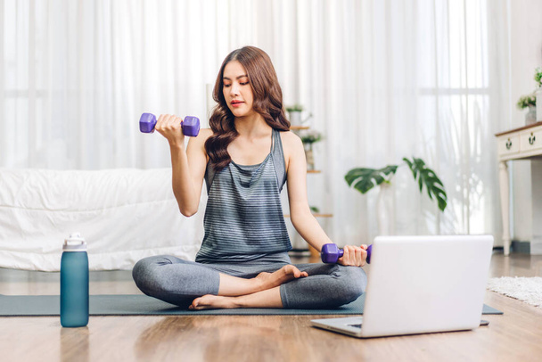 Portrait sport asian beauty body slim woman in sportswear sitting relax and girl practicing yoga and do fitness exercise with laptop computer in bedroom at home.Diet concept.Fitness and healthy - Photo, Image