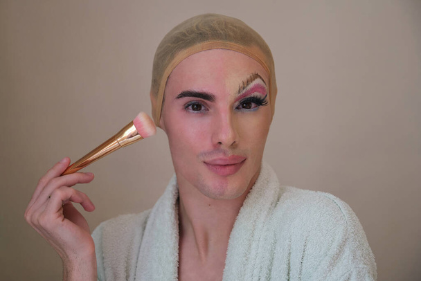 Half man half woman make up person. Drag queen person with a make-up brush. - Photo, Image