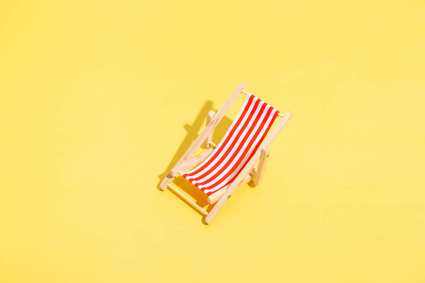 beach chair on a yellow background. Summer minimalist concept - Fotoğraf, Görsel