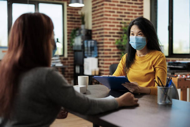 Businesswoman with face mask interviewing potential manager - Photo, Image