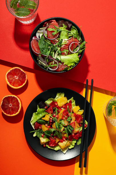 Concept of tasty food, salad with red orange, top view - 写真・画像