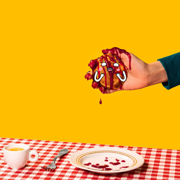 Food pop art photography. Female hand and sweet pancakes with funny drawings on plaid tablecloth isolated on bright yellow background. Vintage, retro style - Φωτογραφία, εικόνα