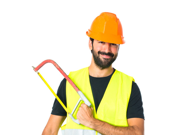 Workman with hacksaw over white background - Foto, afbeelding