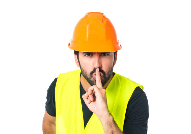 Un ouvrier faisant un geste de silence sur un fond blanc isolé
 - Photo, image
