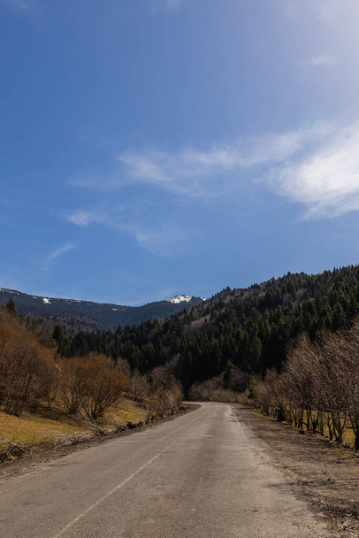 Road, mountains and blue sky at background  - Фото, изображение
