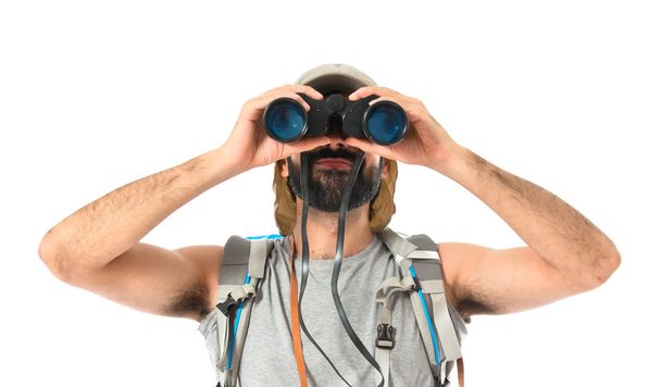 Backpacker with binoculars over isolated white background - Fotoğraf, Görsel