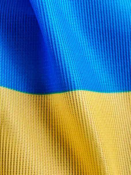Flag of Ukraine. A sky blue and yellow bicolor. Close up waving flag of Ukraine with copy space. - Foto, Imagem