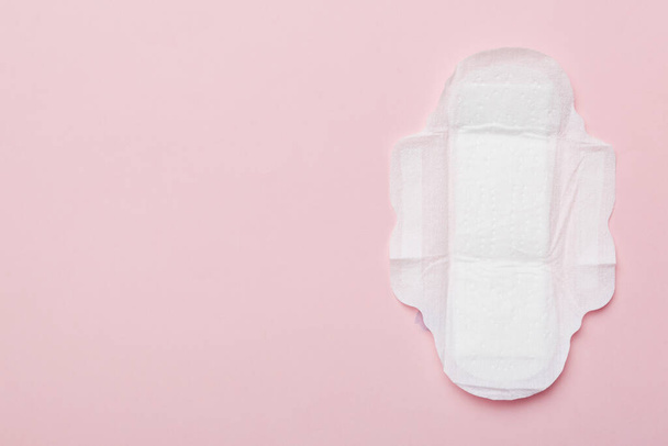 Women hygiene products or sanitary pad on colored background. Pastel color. Closeup. Empty place for text. Female daily hygiene. - Photo, Image