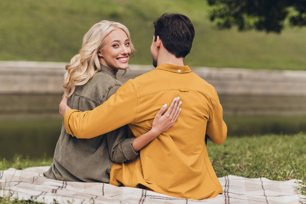 Rear back behind view portrait of amorous adorable cheerful couple spouses hugging enjoying outdoors - Foto, imagen