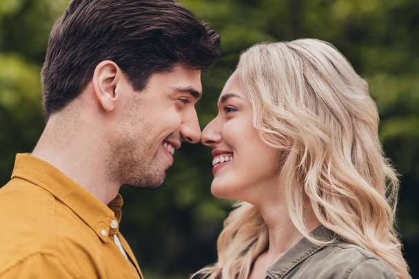 Profile side view portrait of attractive careful cheerful amorous couple enjoying spending free time fresh air outdoors - Fotoğraf, Görsel