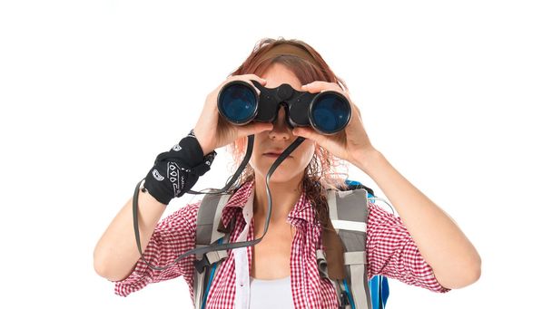 girl looking through binoculars over white background - Photo, Image