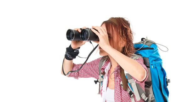 girl looking through binoculars over white background - Foto, afbeelding
