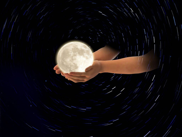 moon  in hands on front blue cloudy sky hold peace concept natire background  - Photo, Image