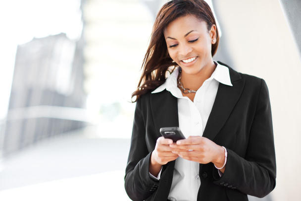 Black businesswoman texting - Photo, Image