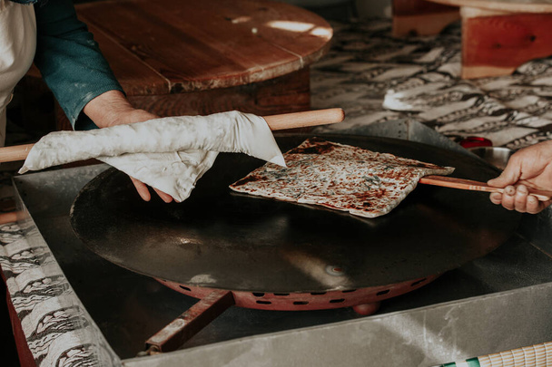 Preparing the cooked pancake for service by cutting it in Antalya Turkey - Fotografie, Obrázek