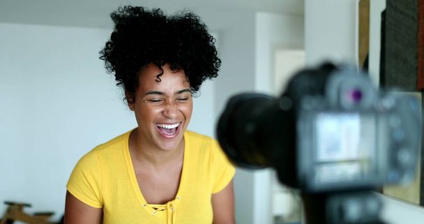 African American female vlogger speaking to social media channel - 写真・画像