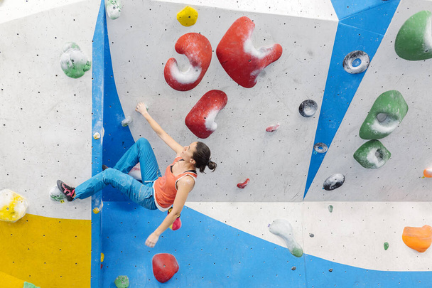 Rock climber woman looking at smartphone. - 写真・画像