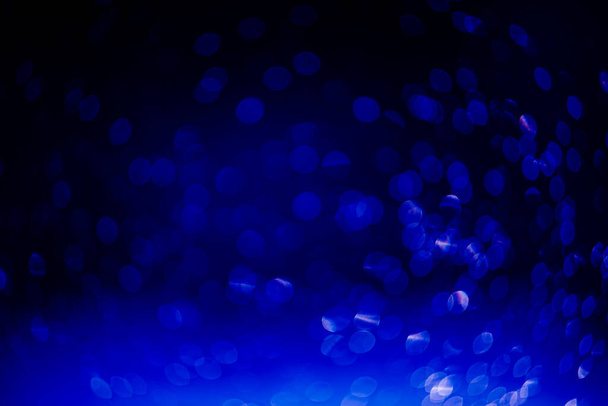 blue bokeh defocused glitter, abstract background with navy blue bokeh on a dark background. - Φωτογραφία, εικόνα