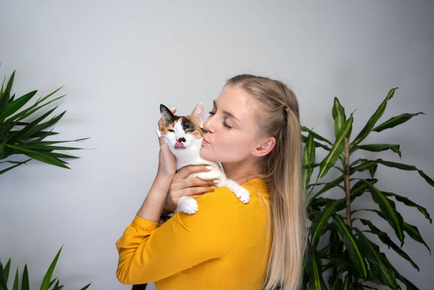 young woman hugging and kissing her cute cat - Fotó, kép