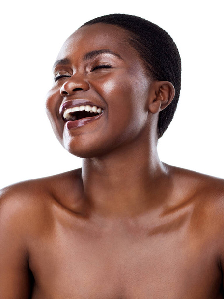 Humor is good for the soul. Studio shot of a beautiful young woman striking a pose and laughing while standing against a white background. - Foto, Imagen