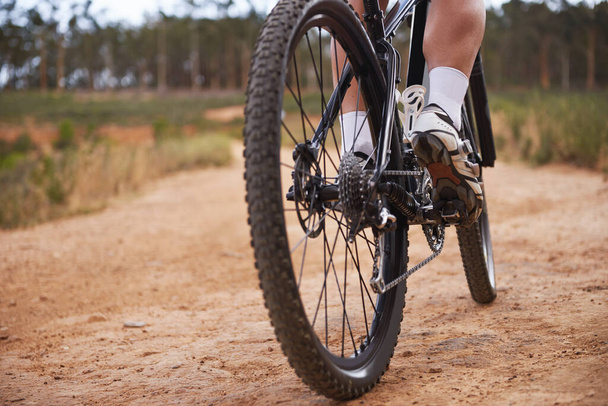 He loves rough terrain. Cropped shot of a cyclist riding outdoors. - Photo, Image