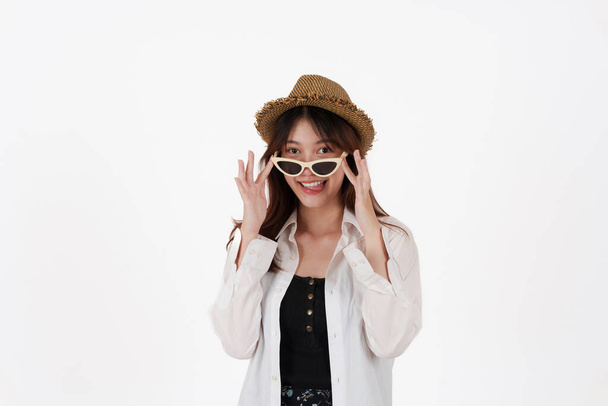 Image of happy young woman wear sunglasses and hat isolated over white background. Travel concept. - Photo, Image