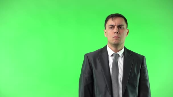 Astonished man in suit touching cheek in studio - Záběry, video