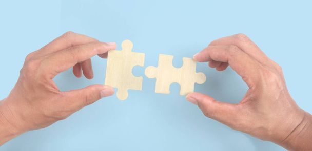 Connecting jigsaw puzzle in  hand. Business solutions success and strategy concept - Photo, Image