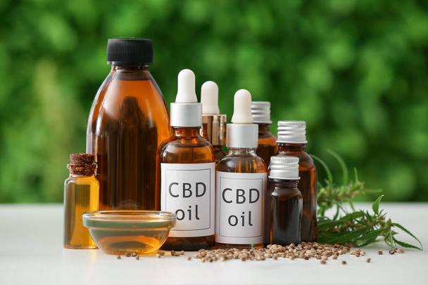 Bottles of CBD oil on table outdoors - Photo, Image