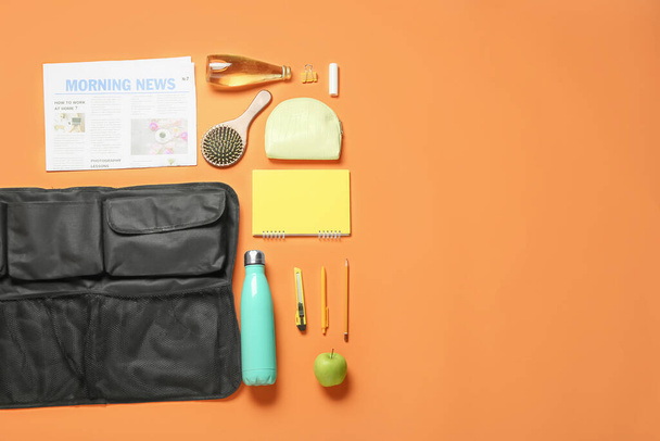 Travel organizer and different things, bottles of drink and apple on color background - 写真・画像