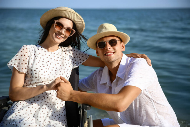 身体障害のある幸せな女性と彼女のボーイフレンドで海のリゾート - 写真・画像