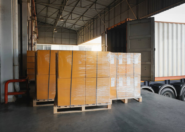 Packaging Boxes Wrapped Plastic on Pallets Loading with Shipping Cargo Container. Trucks Parked Loading at Dock Warehouse. Shipment Supply Chain. Distribution Freight Truck Transport Logistics - Valokuva, kuva