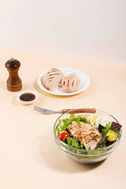 boiled chicken breast and chicken breast salad, white background - Foto, afbeelding