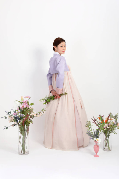 spring beauty concept, beautiful korean woman wearing hanbok with flowers - Foto, Imagem