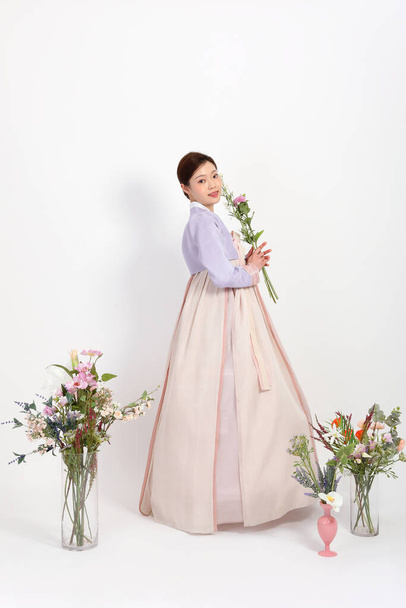 spring beauty concept, beautiful korean woman wearing hanbok with flowers - Фото, зображення