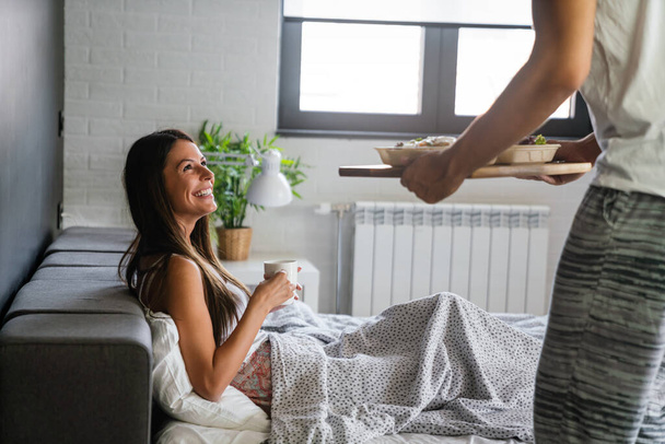 Man bringing the breakfast to his wife in bed. Poeple, couple, love, food concept - Foto, Imagem