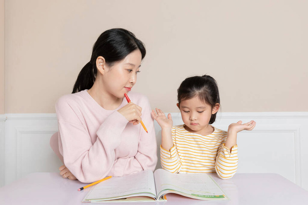 Asian Korean daughter studying with mom - 写真・画像
