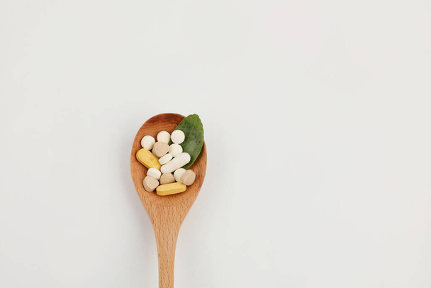 medicine bowl and medicine bottle, white background, medical creative concept photo - 写真・画像