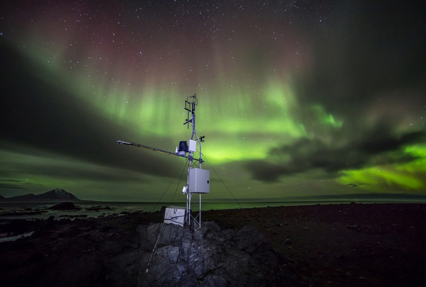 Automatic remote meteo station in the Arctic - northern lights - Photo, Image