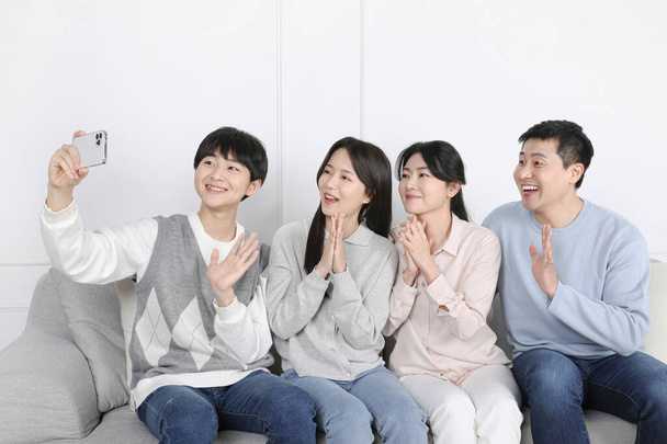 Asian Korean Family Photo of a family having a video call together - Fotoğraf, Görsel