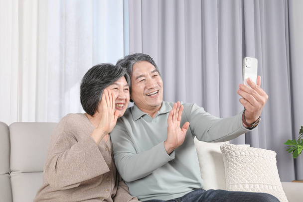Asian Korean Family. An elderly couple having a video call - Photo, Image