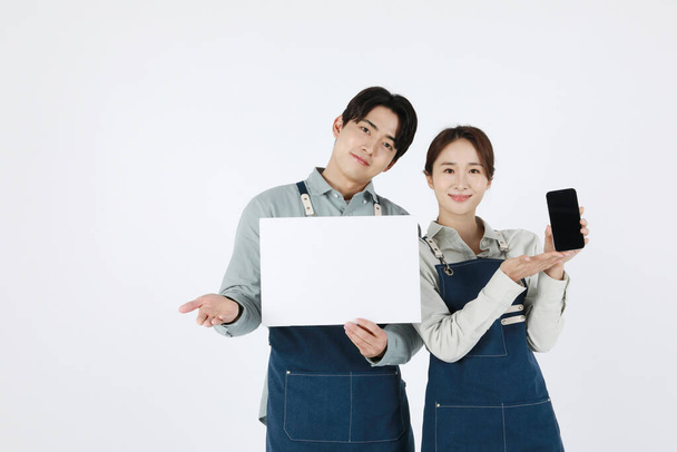 start up concept asian korean young woman and man holding smartphone with panel - Foto, immagini