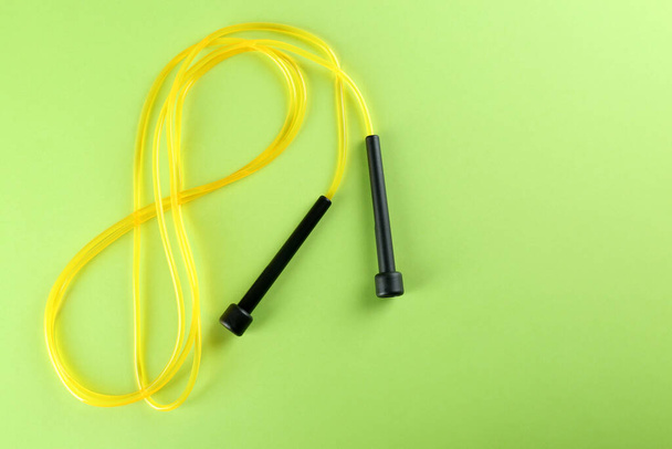 Skipping rope on light green background, top view. Space for text - Foto, immagini